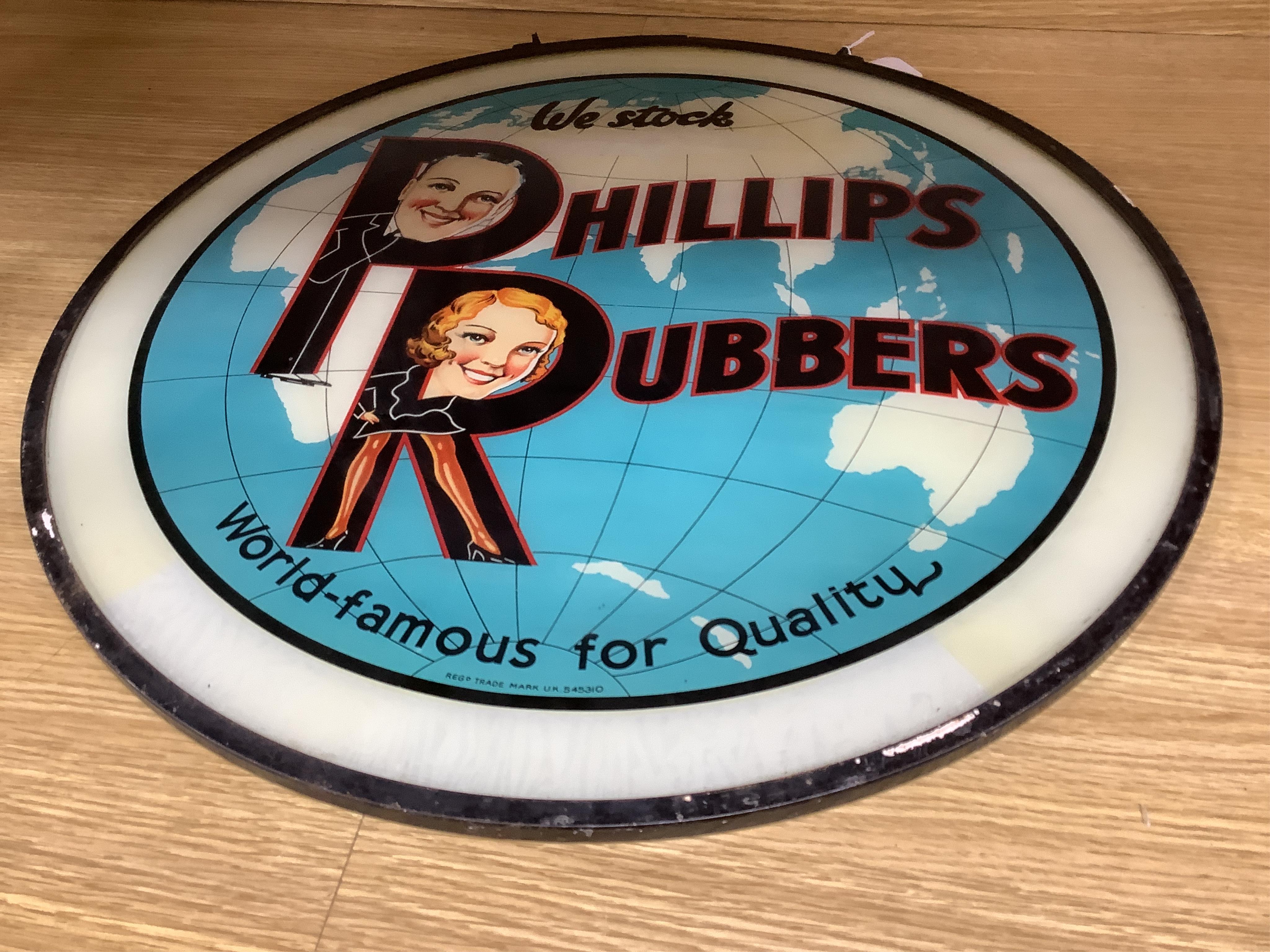 A 1920’s 'Phillip's Rubbers' circular glass advertising sign, 58cm in diameter. Condition - fair